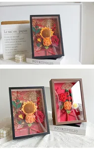 Detail of 3D crochet flower photo frame with sunflowers, roses and ginkgo leaf decor