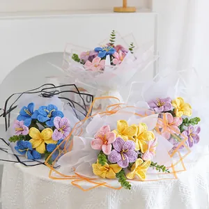 Detailed close-up of handmade crochet flower bouquet with multi-color plumeria blooms