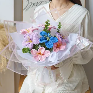 Detail of handmade crochet flower bouquet with lily and eucalyptus in premium gift wrap