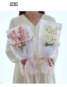 Detailed view of hand-crocheted forget-me-not bouquets with LED lights in pink and white