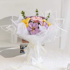 Handmade crochet flower bouquet with purple and pink blossoms in gift packaging
