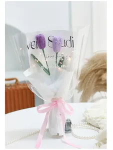 Detail of hand-crocheted purple tulips with LED lights in elegant gift wrapping