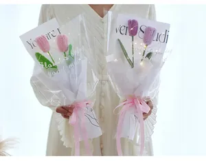 Detail of hand-knitted crochet tulip bouquet with LED lights and elegant ribbon wrapping