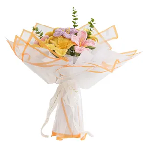 Handmade crochet flower bouquet with lilies and eucalyptus in elegant gift wrapping