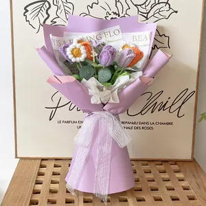Handmade crochet tulip and daisy bouquet in premium purple wrap on a wooden tray