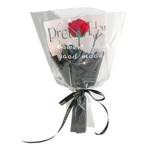 Handmade knitted red carnation flower bouquet with LED lights in premium black gift wrap
