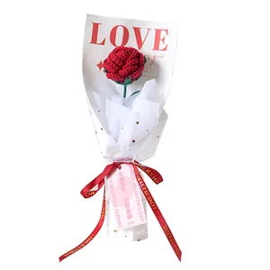 Handmade crochet red rose bouquet in elegant white gift packaging with love ribbon