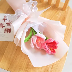 Handmade crochet tulip flower bouquet in pink wrapping paper on a wooden chair