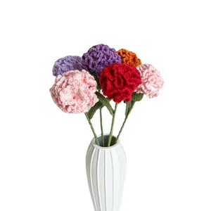 Handmade knitted carnation bouquet in a white ceramic vase for home decoration and gifts