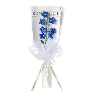 Handmade crochet blue forget-me-not flower bouquet in elegant white gift packaging