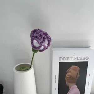 Handmade purple and white knitted carnation flower in a vase for home decor