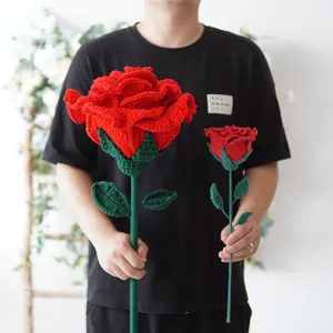 Detailed view of handmade red crochet giant roses showing intricate knit texture