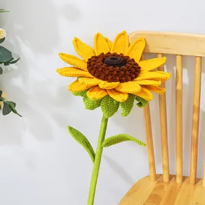 Detailed view of handmade crochet sunflower petals and textured center on wooden chair