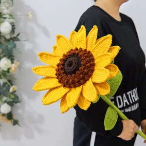 Detailed knit texture of a large handmade crochet sunflower held by a model