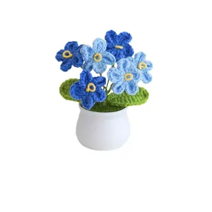 Handmade crochet forget-me-not potted plant in blue with green leaves for home decor