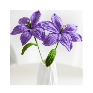 Detail of handcrafted crochet purple lilies with textured petals in a white ceramic vase