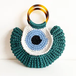 Handmade crochet cotton evil eye handbag with amber resin handles and bohemian green texture