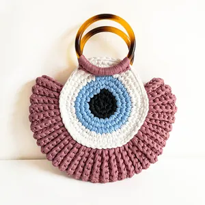 Handmade crochet evil eye handbag with purple woven texture and amber resin handles