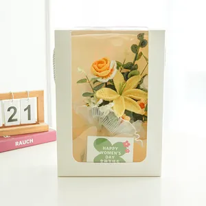 Detail of handmade crochet flower bouquet in white window box with a clover gift card