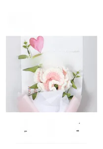 Close-up of handmade crochet carnation bouquet with greeting card in gift wrap