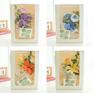 Detail view of handmade crochet flower bouquet gift boxes in four assorted colors