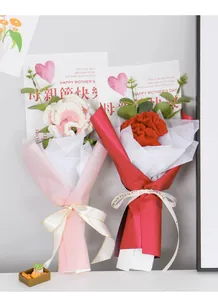 Macro detail of hand-knitted carnation bouquets with Love Eternal silk ribbon