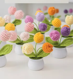 Close-up of handmade crochet tulip potted plants with detailed knitted texture and colors