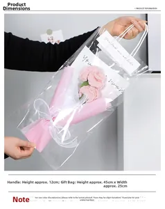 Close-up of handmade pink knitted carnation bouquet in a PVC gift bag with handles