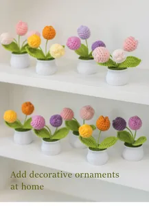 Handmade knitted tulip potted plants in various colors on a white minimalist shelf