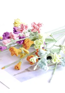 Close-up of handmade crochet freesia flowers with detailed yarn texture and vibrant colors