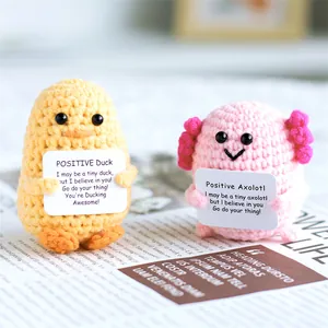 Handmade crochet positive dolls featuring pink axolotl and yellow duck with cards
