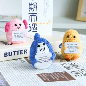 Handmade crochet animal dolls with positive quote cards featuring axolotl, shark and duck
