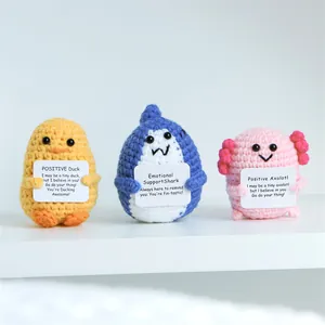 Detailed knit texture of handmade crochet axolotl, shark and duck dolls with gift cards
