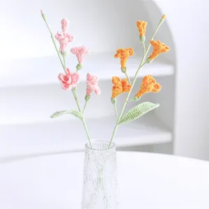Handmade crochet pink and orange freesia flower bouquet in a ripple glass vase