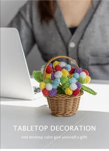 Close-up of handmade crochet puff flower potted plants in a woven basket for desk decor