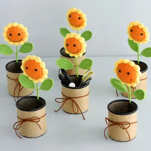Crochet sunflower pen holder with smiling face and decorative brown bow detail