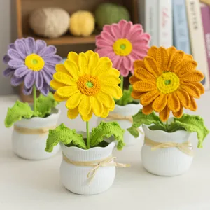 Detailed knit texture of handmade crochet potted flowers in purple and pink on a shelf