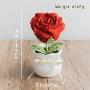Macro shot of handmade crochet red rose in white textured ceramic pot with dimensions