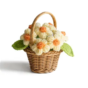 Handmade crochet white daisy flowers in a small brown woven basket desktop decoration