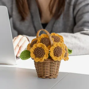Handmade knitted sunflower in a mini basket for desktop decoration and festive gifting
