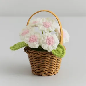 Handmade crochet mini flower basket with white and pink knitted flowers for decor
