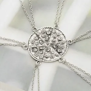 Macro shot of 6-piece pizza slice necklace set in antique silver with skull texture