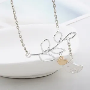 Minimalist clavicle necklace with silver branch and two-tone gold and silver birds pendant