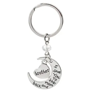 Detail of brother heart pendant and moon charm engraved with I Love You To the Moon and Back