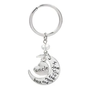 Detail of silver moon and heart keychain engraved with I Love You for Uncle