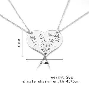 Detailed view of three-piece heart puzzle necklaces with big middle little sis engraving