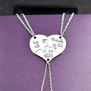 Detailed view of silver heart puzzle necklaces with Big Middle Little Sister engravings