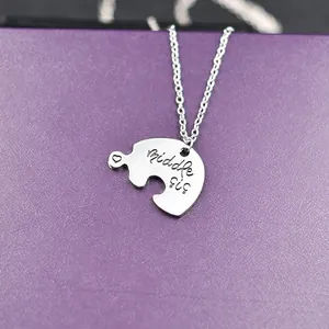 Middle Sister heart puzzle piece pendant necklace on a textured purple background