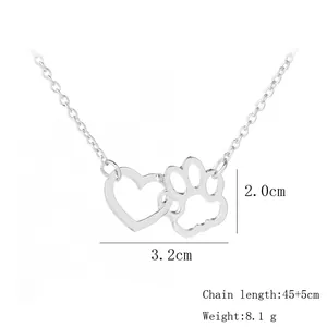 Detail shot of heart and dog paw pendant with dimensions 3.2cm wide and 2.0cm high