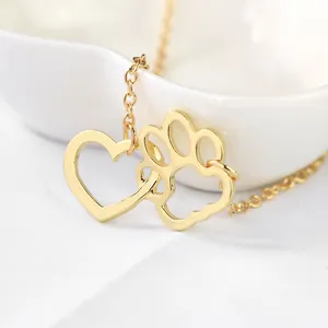 Polished gold necklace featuring minimalist heart and dog paw prints double pendant